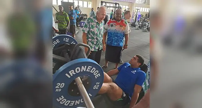 Fijian Drua captain Meli Derenalagi on one of the exercise machines at the Drua Home Base in Nadi with World Rugby chairman Sir Bill Beaumont, standing left, and Fiji Rugby chairman Humphrey Tawake on October 10, 2022. Photo: Waisea Nasokia