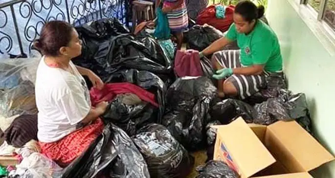 The families of those affected by TC Harold in the village of Makadru in Matuku, Lau, sort out clothes and food supply that will be sent to the village.
