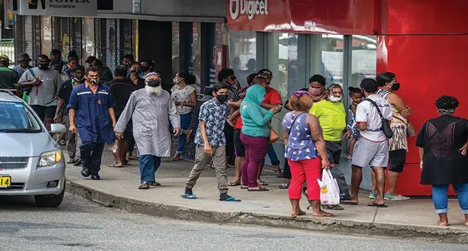 Fijians gathered outside a Digicel outlet in Suva after receiving their first payout of the Government Asssistance. Photo: Leon Lord