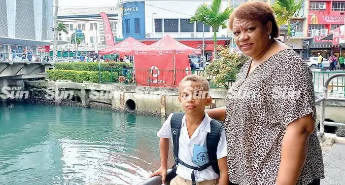 Flori Tokana with son, Akariva Tokana, at the same spot where she saw the waste discharge in Nubukalau creek. Photo: Ronald Kumar