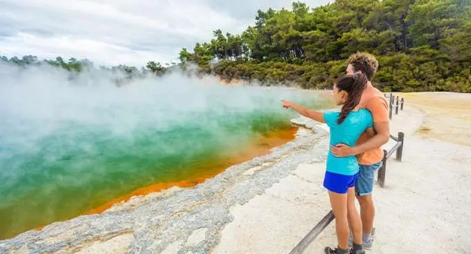 Tourists visiting Champagne Pool at Wai-O-Tapu thermal park in Rotorua, New Zealand.