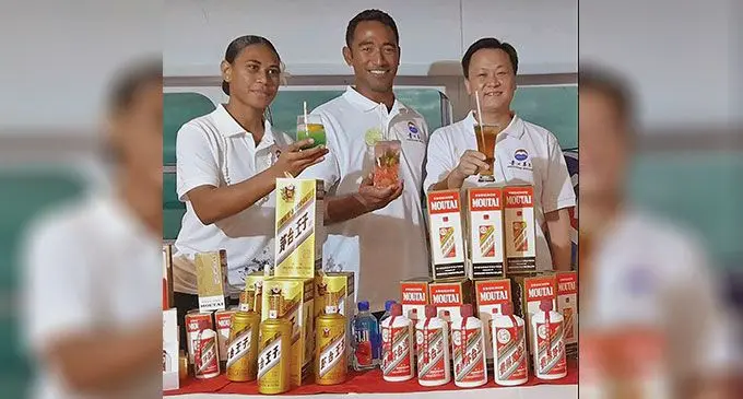 From left, Suluana Tikoigidi, Immanuel Pau’u and Moutai managing director Danny Cheng with some of the beverages. Photo: Waisea Nasokia
