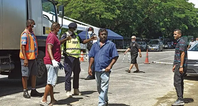 Truck drivers requesting Police officers to cross checkpoints at the Momi junction on April 20, 2021. Photo: Mereleki Nai