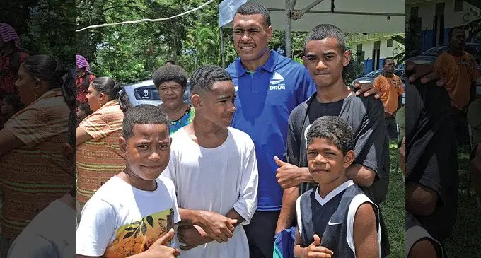 Swire Shipping Fijian Drua squad member Michael Naitokani (wearing blue shirt), with fans in Ba on December 3, 2022. Photo: Waisea Nasokia
