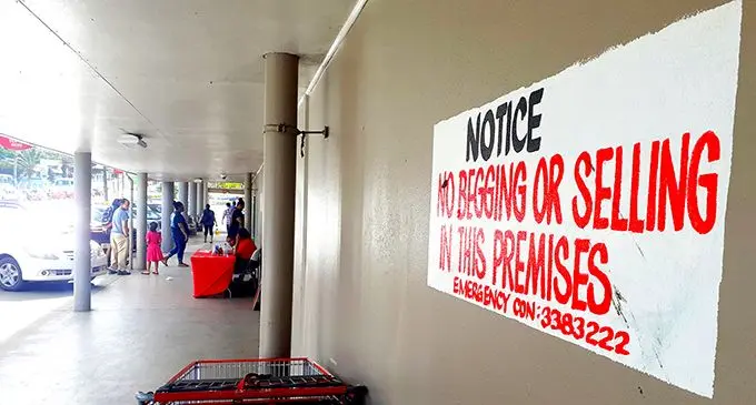 Cost U Less in Suva has put up security and sign to stop people begging and peddling on their premises. Photo: Ronald Kumar