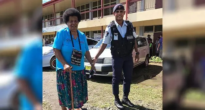 Kenita Tuirani assisted by Police Constable Mohammed Zaid at the All Saints Secondary School polling venue at Labasa on December 14, 2022. Photos: Shratika Naidu