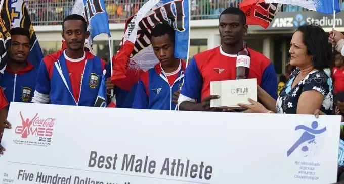 Marist Brothers High School senior athlete Mustafa Fall (second from right),  receives his Best Male Athlete Award from the Minister for Women, Children and Poverty Alleviation, Rosy Akbar at the the ANZ Stadium, Suva, Photo: Rama
