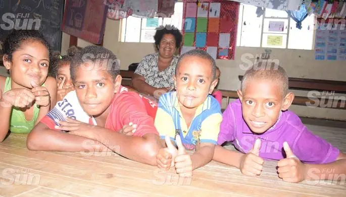 Keyasi Siva 47 (sitting at the back) with Children from Wainividio Settlement in Navua (from left) Makitalena MManiova, Nanise Marama, Jonetani Kovelali, David Carl, Elizabeth Sivowale and Inia Bola were part of the twelve families that took shelter at Vashist Muni Memorial Primary School. 