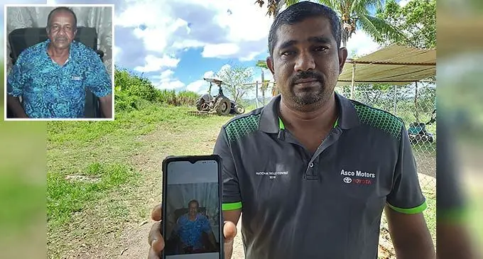 Raymond Chandra, 40 holds a photo of his late father. Photo: Waisea Nasokia