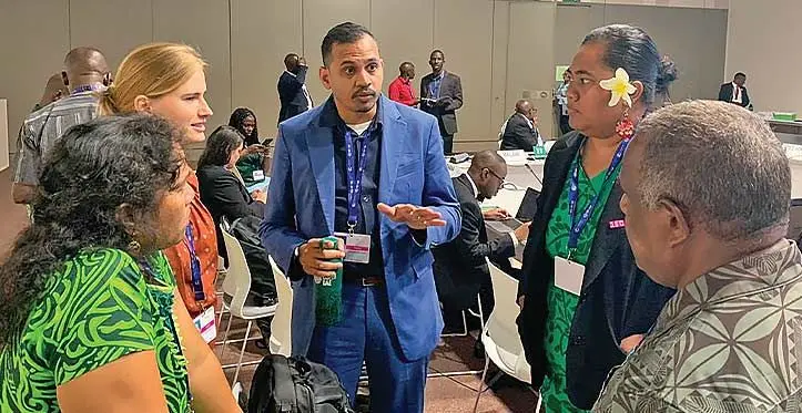 Pacific islands Adaptation negotiators discussing textual proposals for AOSIS during the informal consultations on Global Goal for Adaptation on December 3, 2023.