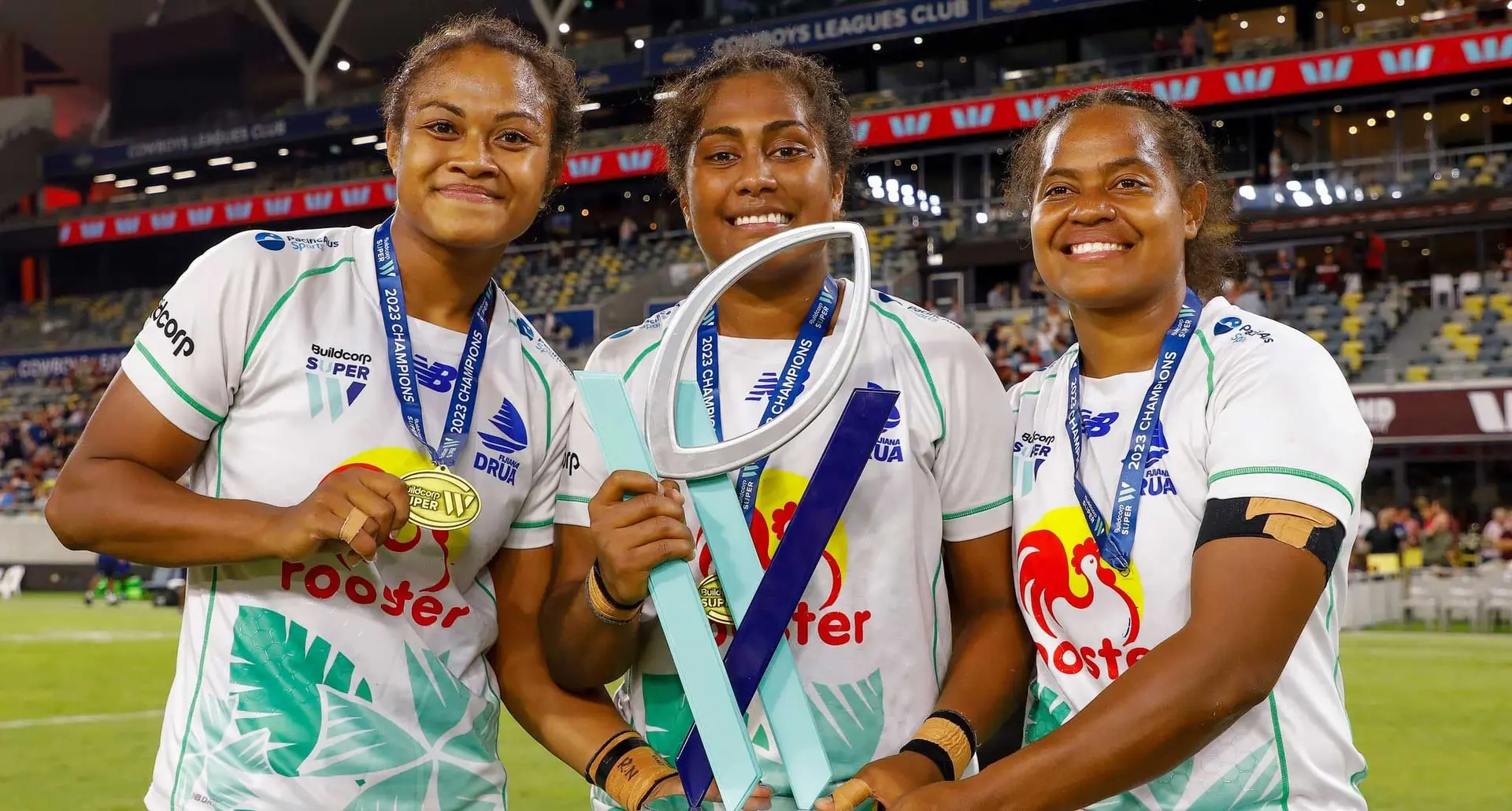 Rooster Chicken Fijiana Drua players (from left), Asinate Serevi, (vice-captain), Bitila Tawake (captain) and centre Vani Arei with the Super W title after the beating Reds 38-30 in the grand final at the Queensland Country Bank Stadium in Townsville, Australia, on May 6, 2023. Photo: Rugby Australia