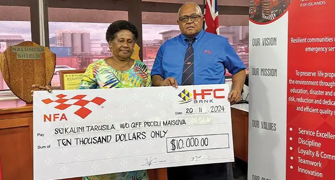 National NFA chief executive offficer Puamau Sowane (right) presents a Term Life benefit of $10,000 to Sei Kalini Tarusila, the widow of Qualified Firefighter Peceli Maisuva.
