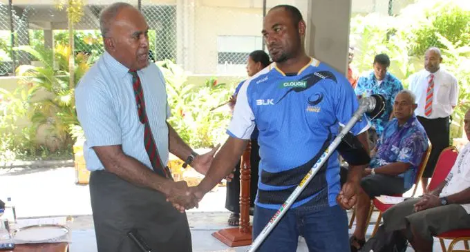 Minister  for Youth and Sports Laisenia Tuitubou handing over the assistance to Vitieloma Youth Cub president  Asivili Tikinatabua on February 22, 2018. Photo: Ministry of Youth and Sports