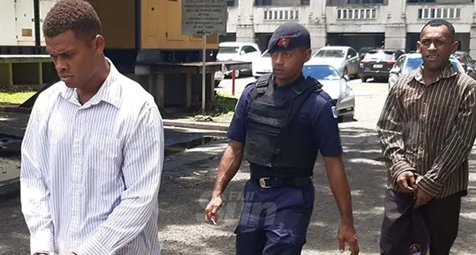 Tevita Badogo (front) and Eroni Bale (last) are being led by Police officers to the Magistrates Court on January 6, 2021. Photo: Shalveen Chand