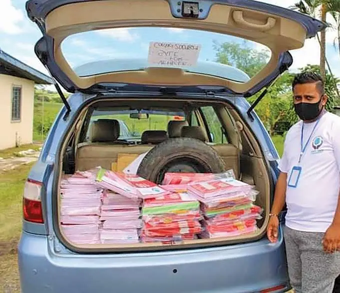 Nakasi Youth Club president, Mohammed Shafil before distributing books to some children residing in Ba.