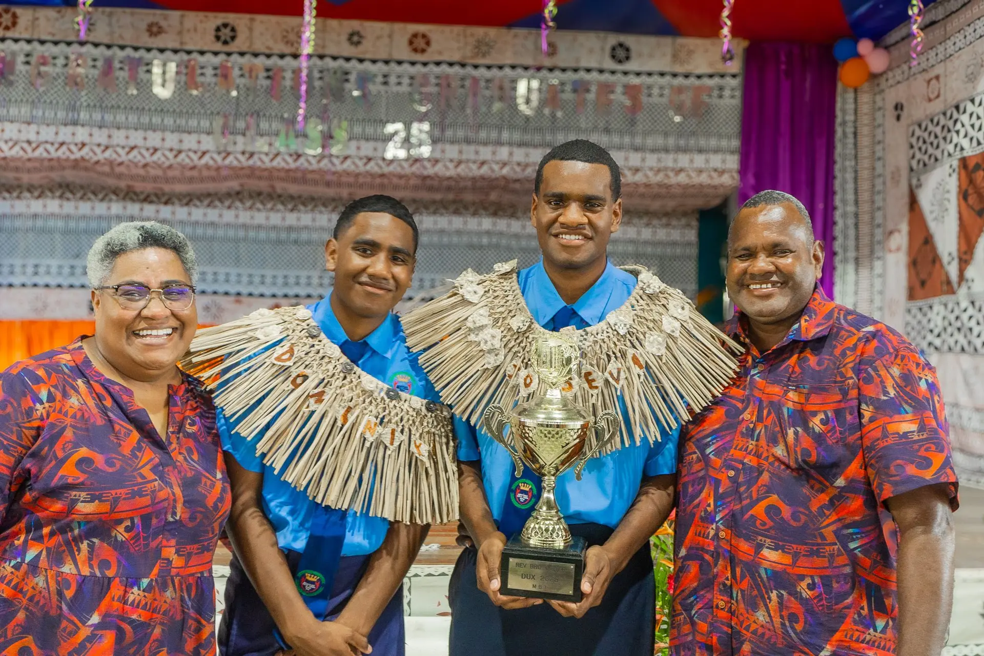 From left: Salome Navarro (mother), graduates Dominiko Kaikaba and Joseva Kaikaba — who received the Dux award — with their father, Lario Kaikaba, after the Montfort Boys Town graduation in Veisari on November 22, 2025.
