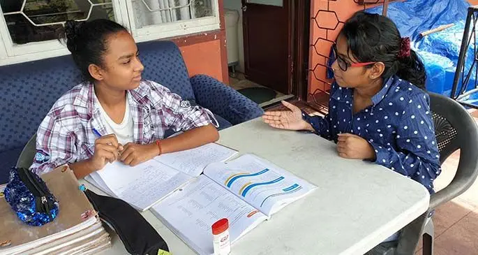 Tanushka Nand tutors her niece at their home in Samabula on April 17, 2020.