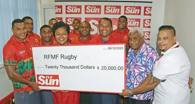Fiji SUN Managaing Editor Digital and Readership Development Rosi Doviverata (fourth from left), Managing Editor Training,Nemani Delaibatiki (second from right) and Markerting Manager Rajiv Raj (right) during the cheque presentation to the Subrails Republic of Fiji Military Forces (RFMF) rugby team for the FMF Rise Fiji Rise Sukuna Bowl Challenge in Suva, on December 9, 2020. Photo: Ronald Kumar