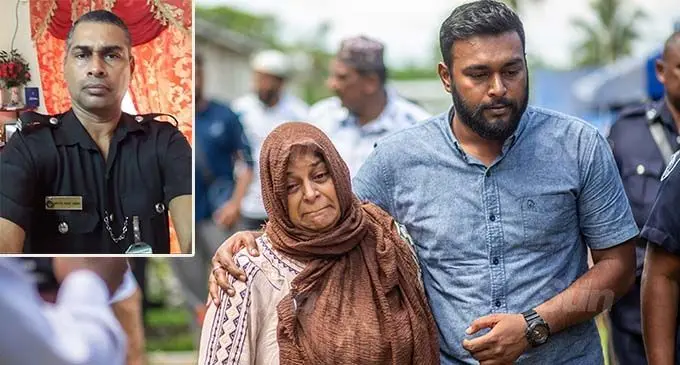 Razia Iqbal (L) widow of the deceased police constable Asaf Iqbal comforted by her son Fauzan Iqbal during the funeral procession in Raiwai on the January 14, 2021. Photo: Leon Lord Inset (In happier days....Accident victim, Police Constable Asaf Iqbal, 50.