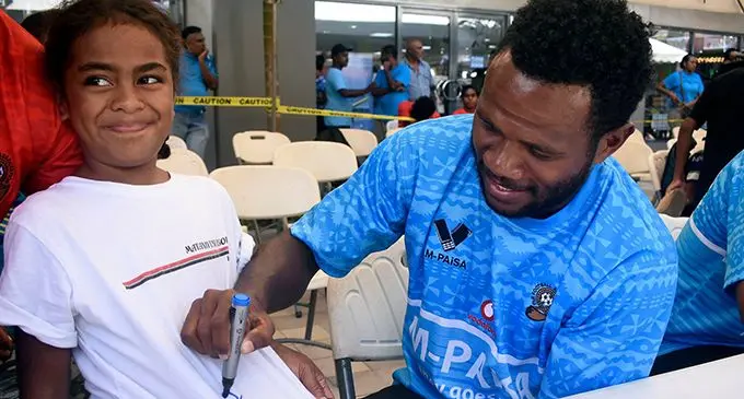 Suva defender and Vodafone Fiji football team captain Laisenia Raura signing an autograph on March 16, 2019.