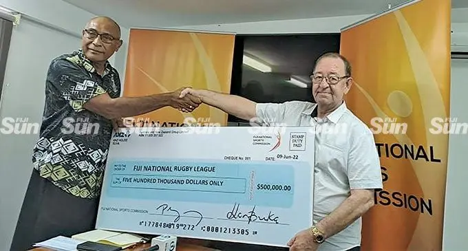 Fiji National Rugby League chairman, Viliame Naupoto (left) receives the cheque from Fiji National Sports Commission (FNSC) executive chairman Peter Mazey at the FNSC office, Laucala, Suva, on June 9, 2022. Photo: Simione Haravanua