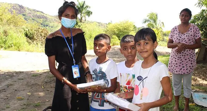 Nakasi Youth Club co-ordinator, Jiya Prasad (left) out assisting children at Lomolomo, Lautoka.