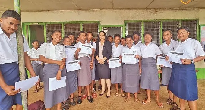 Minister for Education, Heritage and Arts Rosy Akbar with the students who were recipients of vouchers at Lekutu Secondary School.