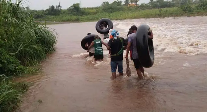Caption: Youth carrying the deceased body across the Toge River in Ba yesterday. Photo: Supplied
