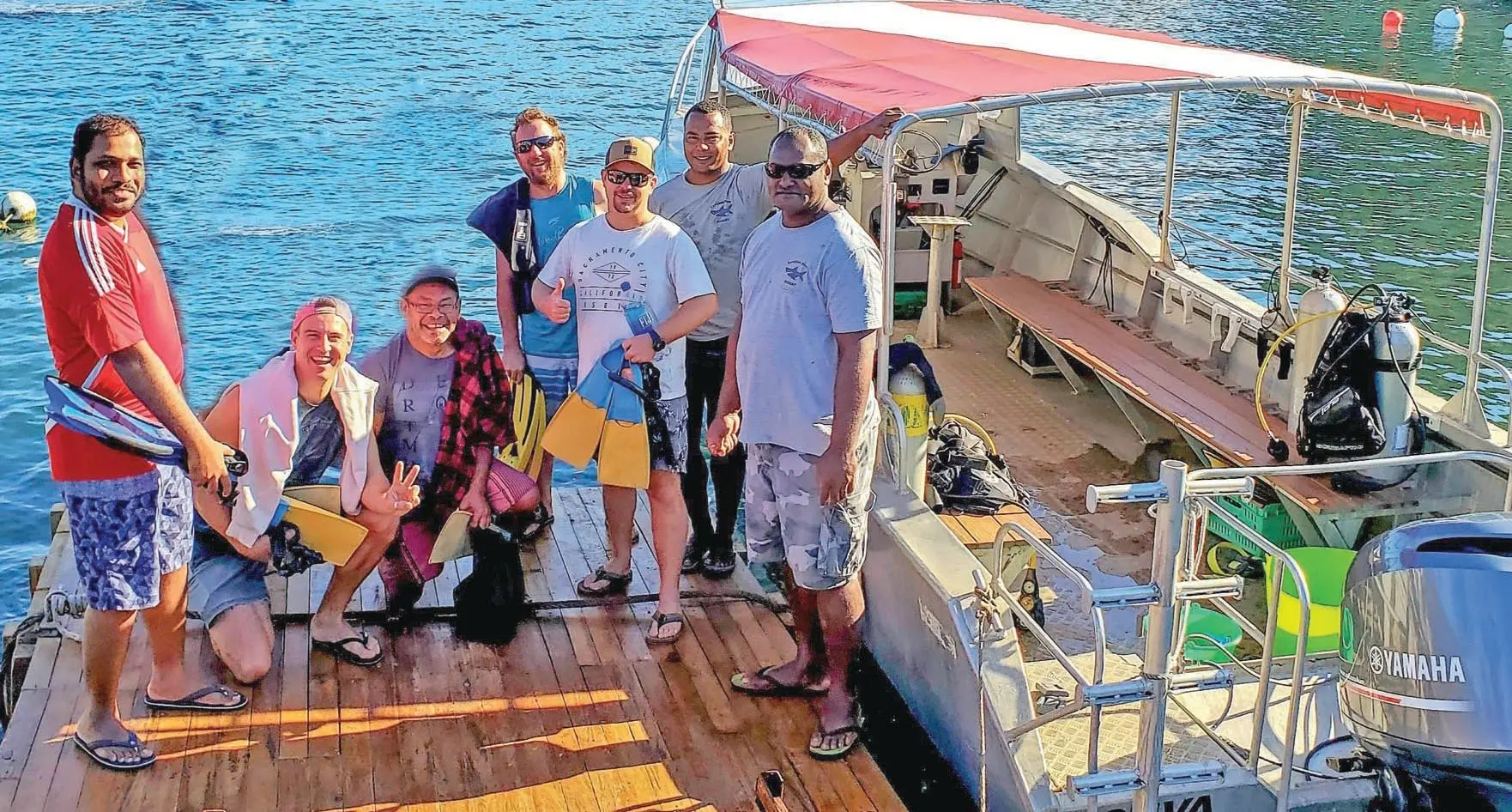 A group departing from the Taveuni Dive Resort marina for a morning dive and snorkel trip at Rainbow Reef. 