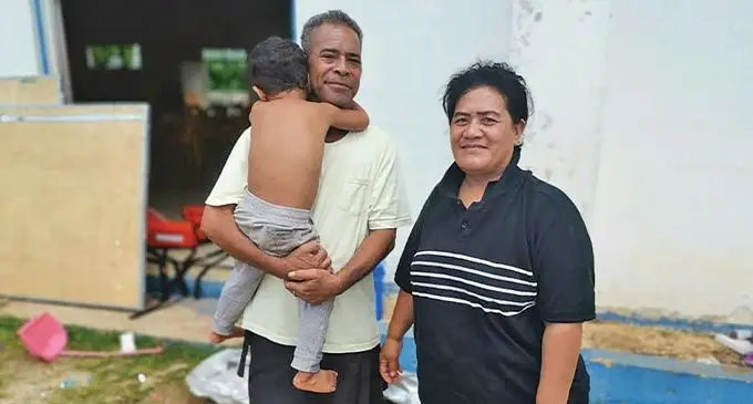 Mango town officer Sione Vailea with wife and child. Photo: RNZ Pacific
