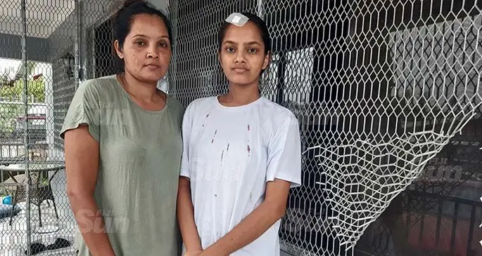 Fozia Sharnaz (left) with her daughter Zaira at their home in Khalsa Road. The burglar bars were bent for entry into the house. Photo: Shalveen Chand