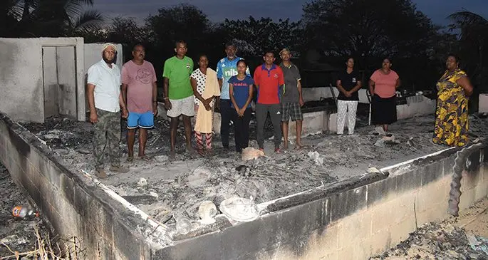 Fire victims with relatives at their home on Sunday. Photo: Waisea Nasokia