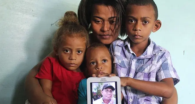 From left Sheila Boseiwaqa 4, Herbert Junior 3, Kesaia Lewacei (wife) and eldest son Josh Boseiwaqa hold a picture of their late father Herbet Smith Boseiwaqa at their home in Narere Suva on August 26,2019. Photo: Simione Haravanua.