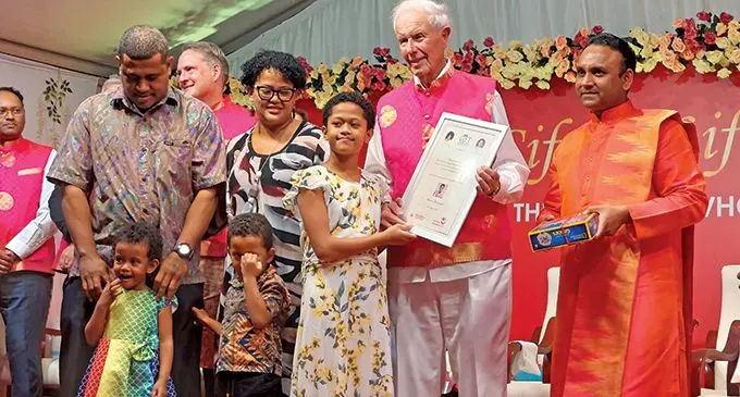 Bulou Marisela Rokobuli with her family receives her certificate from Robert Bozzani,  Philanthropist from the United States of America and Sadguru Sri Madhusudan Sai on May 7, 2022.  Photo: Wati Talebula-Nuku