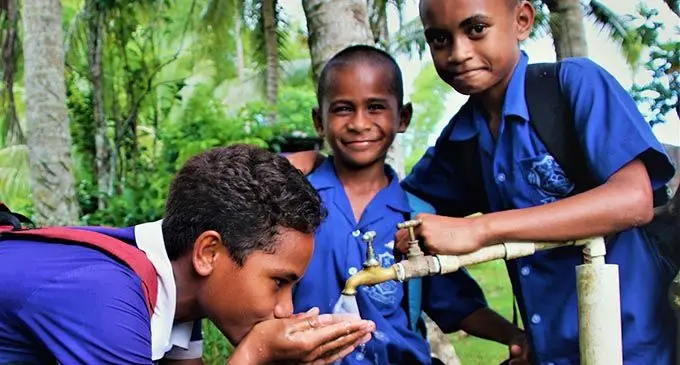 Students return to their home in Vatulovona to enjoy a drink of clean water.  Photo: Water Authority of Fiji