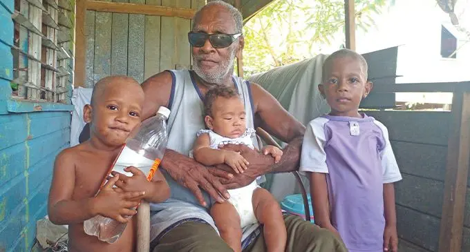 From left: Ratu Lekini Vasukiwai (Jnr) holding the two-litre water bottle, Lekini Vasukiwai with baby Merini Tokawavivi, Inise Tuinikula at their home in Naivikinikini Village on April 14, 2023. Photo: Jone Salusalu