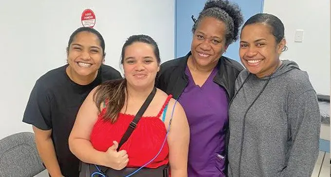 A pioneer patient at PSH with hospital staff showing the belt that is worn and records images taken by the Pill Cam. Photo: Pacific Specialists Healthcare