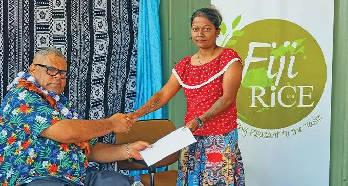 Minister for Agriculture and Waterways, Vatimi Rayalu handed over a planting grant application form to female farmer, Moreen Ram in September, 2024. Photo: Sampras Anand