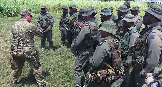 NZ Army Staff Sergeant Dave Foothead advises on instructional techniques during a course for shooting coaches in Fiji.