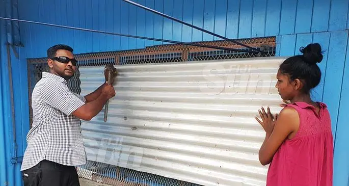 Nikhil Chand and wife Sharin Shanita barricade windows at their home in Lautoka in preparation for the possible storm headed Fiji’s way. Photo: Nicolette Chambers
