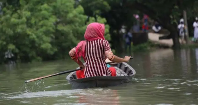 A girl rows a boat in a flooded area in Munshiganj on the outskirts of Dhaka, capital of Bangladesh, on July 27, 2020. (Xinhua)