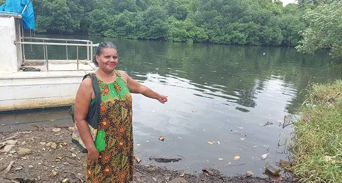 Vunisaleka Settlement resident, Lusiana Rokomarama points to the polluted river.  Photo: Wati Talebula-Nuku