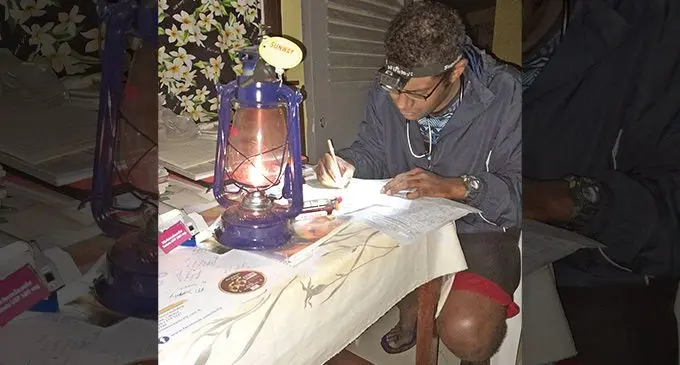 Dr Lemeki Ravena, during an emergency case, used a kerosene lamp and portable head torch to attend to the patient.  Photo: Supplied 