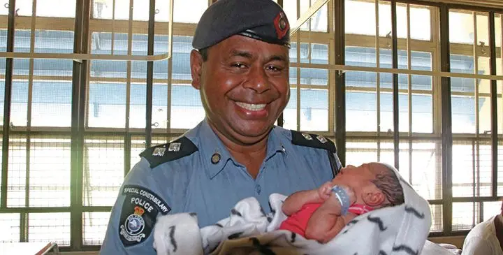 Special Inspector of Police Penijamini (Ben) Vukivou with the newborn baby.