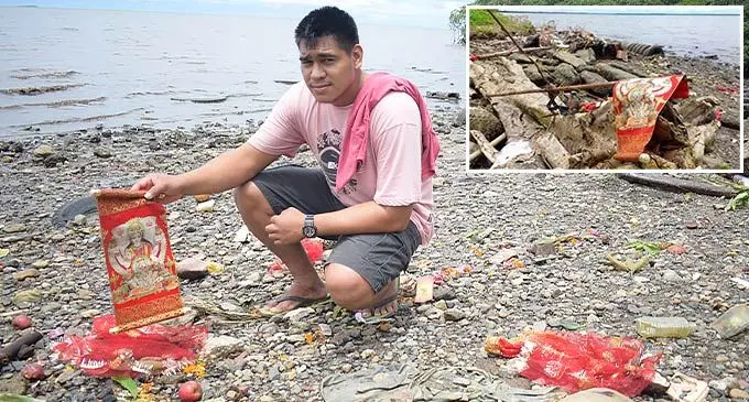 Joseph Fesaitu, a concerned youth said he was disturbed to see Hindu gods and prayer material washed ashore near Bulei Road, Laucala Beach, on October 27, 2022. Photo: Ronald Kumar Top Inset: The mess left by Hindu devotees along the shores near Bulei Road in Laucala Beach on October 27, 2022. Photo: Ronald Kumar