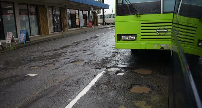Drivers manoeuvre through potholes filled with water after the continuous downpour on April 22, 2019.  Photo: Ronald Kumar 