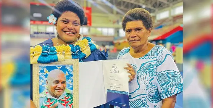 Adi Sera Gonerara, with her mother Mereani Dua, and a picture of her late father, during the Fiji National University graduation ceremony on April 16, 2025. Photo: Rariqi Turner