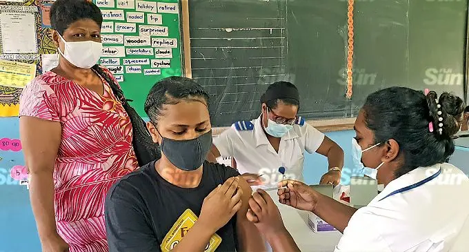 Jasper Williams High School student, Mereia McGoon getting her Pfizer vaccine while her mother, Vasitia watches on at Saint Thomas Primary School in Lautoka on November 16, 2021. Photo: Nicolette Chambers