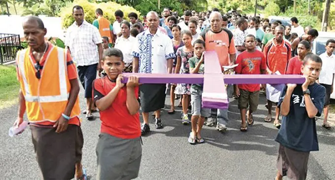 Members of the Catholic Church community in Fiji carrying the cross on the streets as a lead up to Easter.