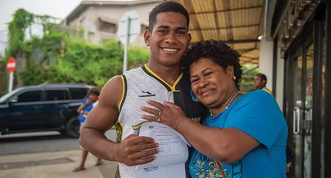 Queen Victoria School year 12 student Mikaele Vueti {left), with his mother Josivini after collecting his results at the Ministry of Education headquarters in Toorak, Suva, on January 18, 2024. Photo: Leon Lord